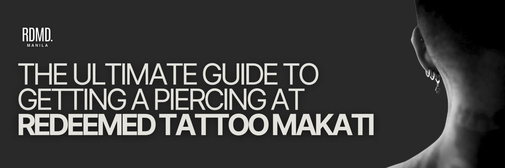 "THE ULTIMATE GUIDE TO GETTING A PIERCING AT REDEEMED TATTOO MAKATI" is displayed in large, bold white letters on a black background. The RDMD. MANILA logo is placed in the top-left corner. On the right side of the image, a black-and-white photograph shows